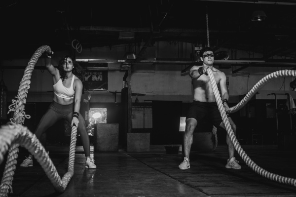 photo of 2 people working out with battle ropes