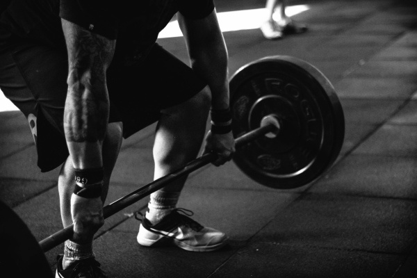 photo of a person performing a deadlift with a barbell