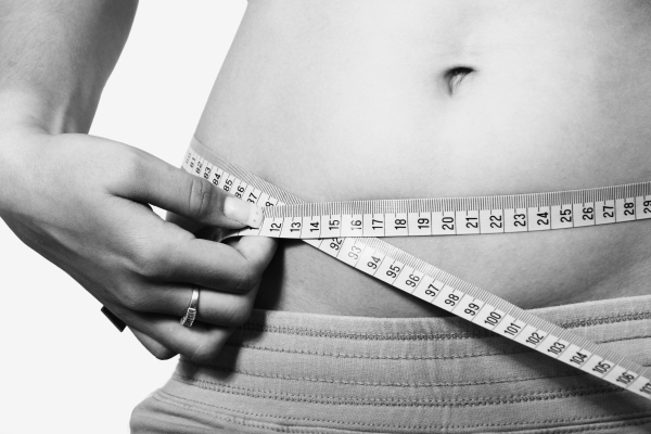 photo of a girl measuring her belly circumference